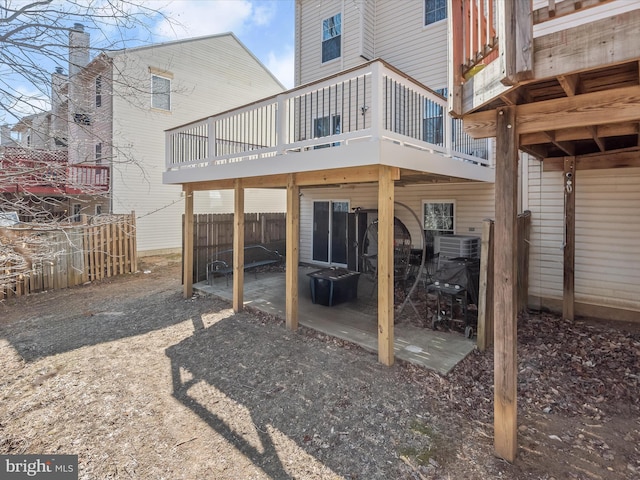 rear view of property featuring a deck, a patio, fence, and central air condition unit