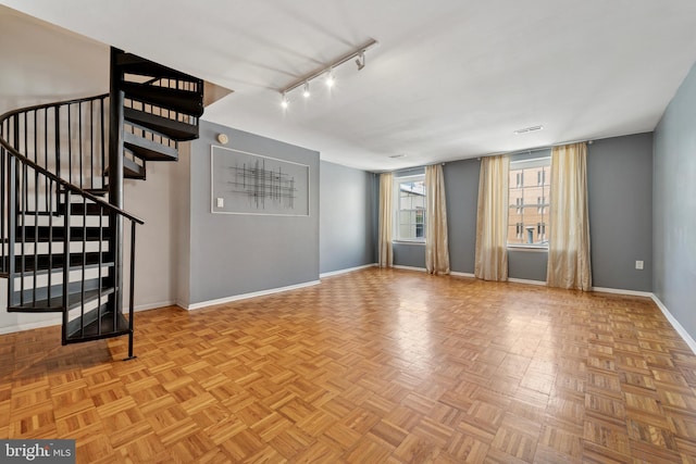 1029 Spruce St Unit 304, Philadelphia, PA 19107 - unfurnished living room with stairway, track lighting, and baseboards