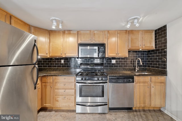 1029 Spruce St Unit 304, Philadelphia, PA 19107 - kitchen featuring light brown cabinetry, a sink, dark stone countertops, stainless steel appliances, and tasteful backsplash