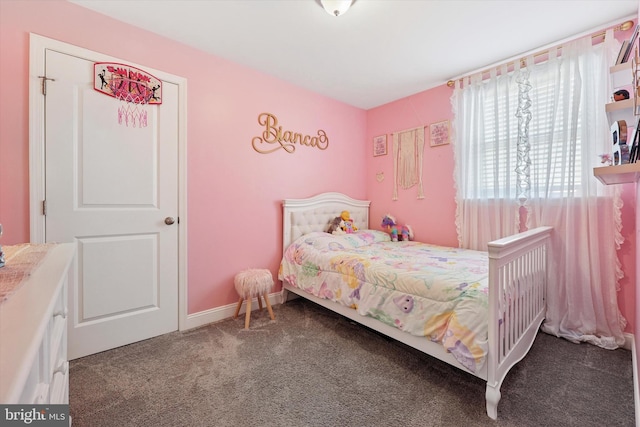 bedroom with carpet floors and baseboards