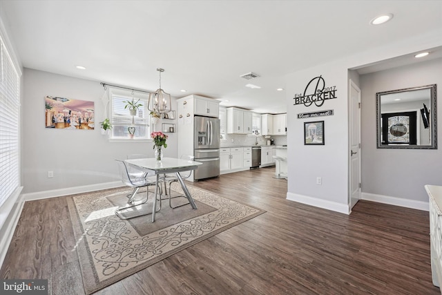 unfurnished dining area featuring baseboards, visible vents, dark wood finished floors, and recessed lighting