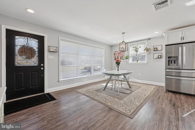 foyer with recessed lighting, visible vents, baseboards, and wood finished floors