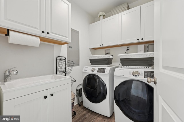 laundry room with cabinet space, electric panel, dark wood-style floors, independent washer and dryer, and a sink