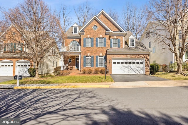 view of front of home featuring aphalt driveway, a balcony, and brick siding