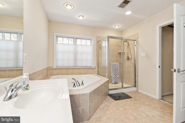 bathroom with visible vents, a garden tub, a stall shower, a sink, and tile patterned flooring