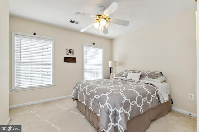 bedroom featuring visible vents, multiple windows, baseboards, and carpet