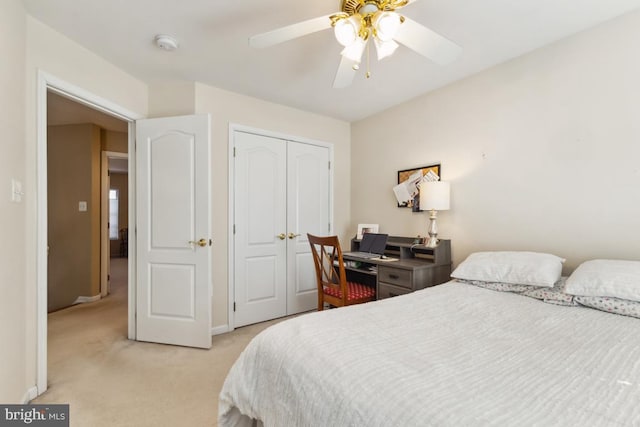 bedroom featuring a ceiling fan, light colored carpet, a closet, and baseboards