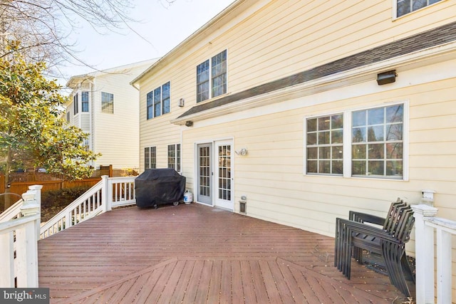 wooden terrace featuring area for grilling and fence