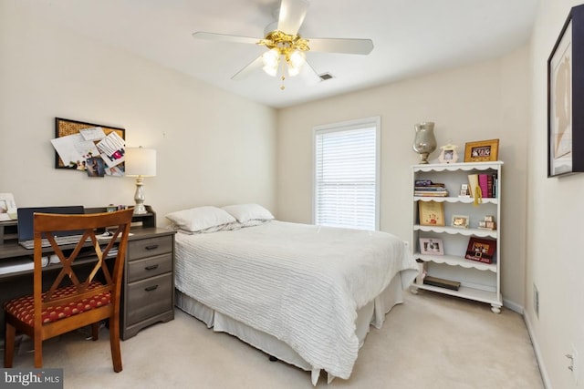 bedroom featuring a ceiling fan, baseboards, visible vents, and light carpet