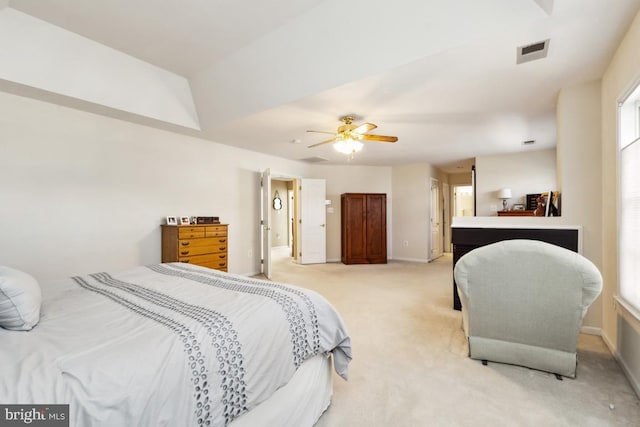 bedroom with visible vents, light colored carpet, a ceiling fan, and baseboards