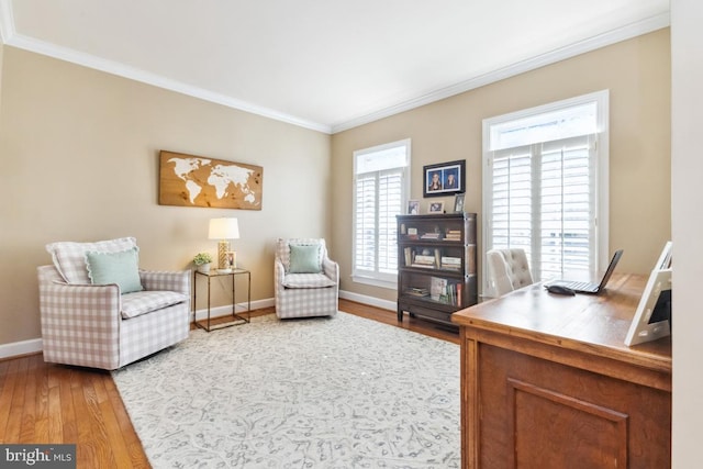 office area with crown molding, wood finished floors, and baseboards