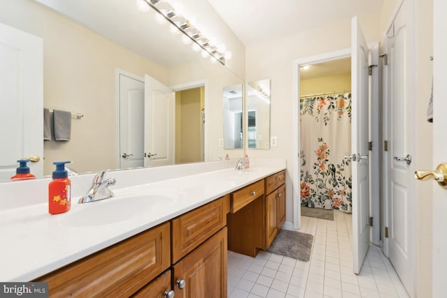 full bath with double vanity, tile patterned flooring, and a sink