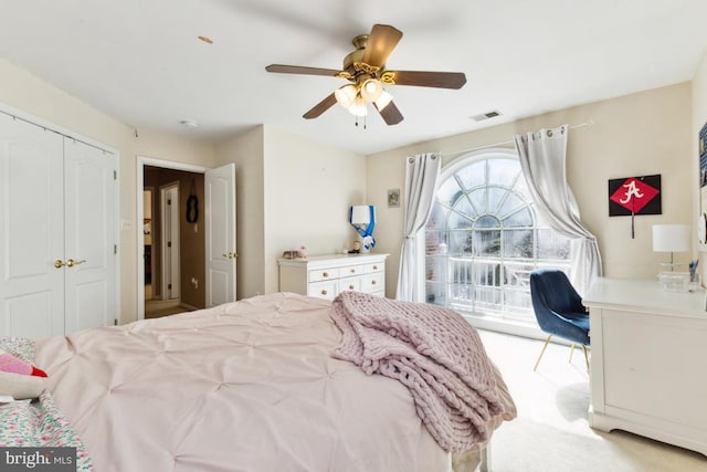 carpeted bedroom with visible vents, access to exterior, and a ceiling fan