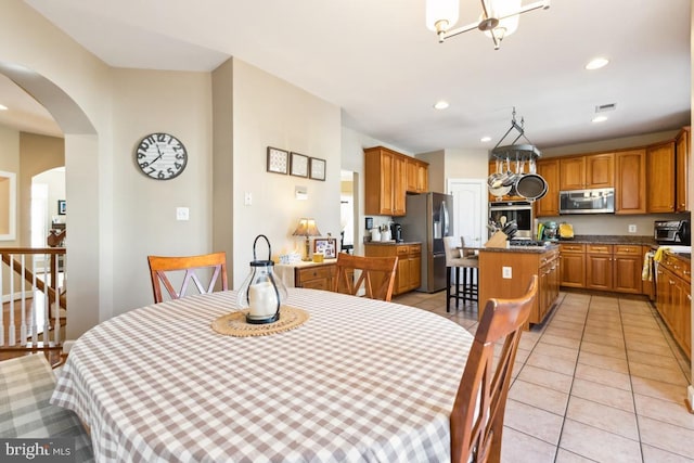 dining space with visible vents, a notable chandelier, recessed lighting, light tile patterned flooring, and a toaster