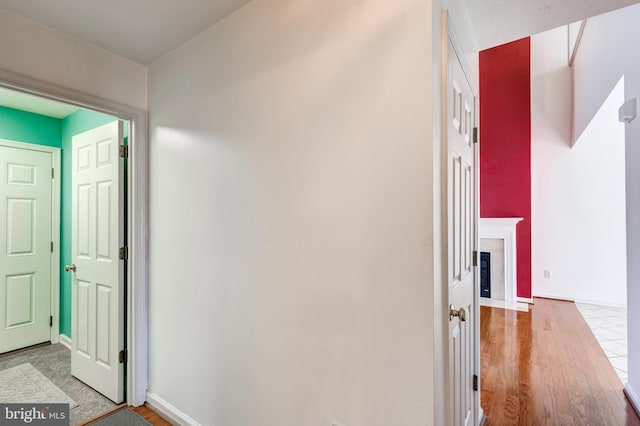 hallway featuring baseboards and wood finished floors