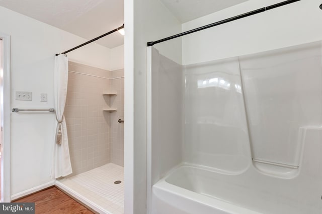 bathroom featuring a shower with shower curtain and wood finished floors