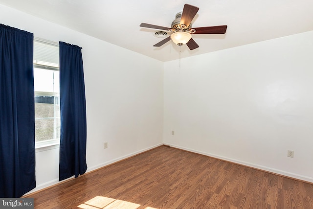 unfurnished room with baseboards, a healthy amount of sunlight, wood finished floors, and a ceiling fan