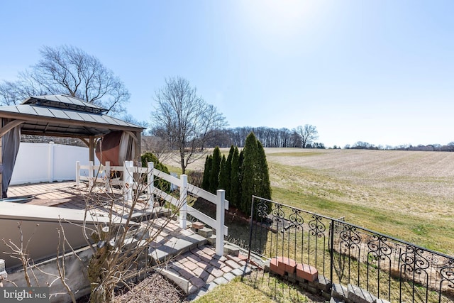 exterior space featuring a gazebo, a rural view, and fence