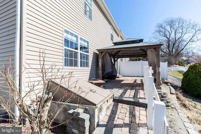 view of patio / terrace featuring a gazebo and fence