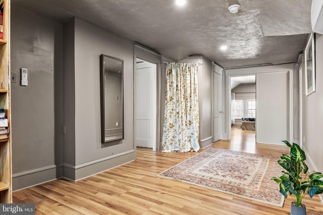 interior space featuring wood finished floors and baseboards