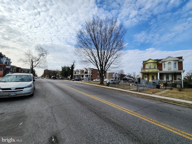 view of street featuring sidewalks, a residential view, and curbs