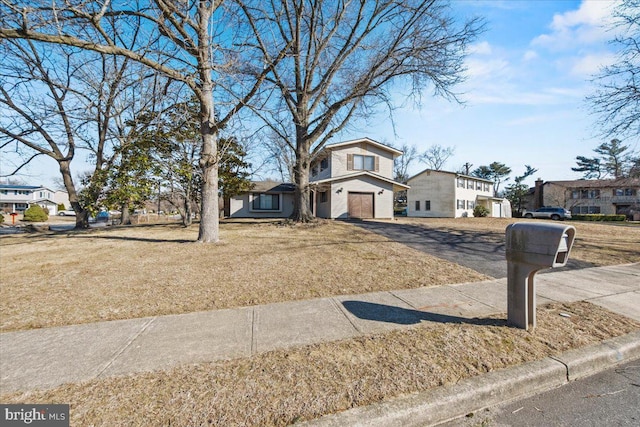 split level home featuring a front yard and driveway