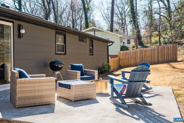 view of patio featuring fence and an outdoor hangout area