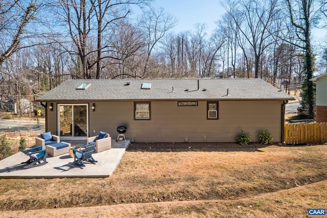 rear view of property featuring a yard, roof with shingles, a patio area, and fence