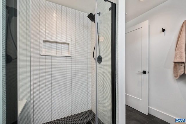 full bathroom featuring baseboards, a shower stall, and tile patterned floors