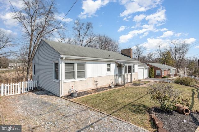 view of front of home featuring driveway, fence, an attached garage, brick siding, and a chimney