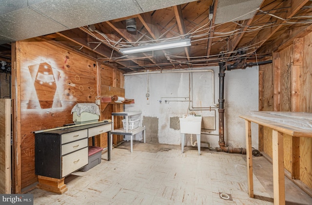 unfinished basement featuring tile patterned floors and a sink