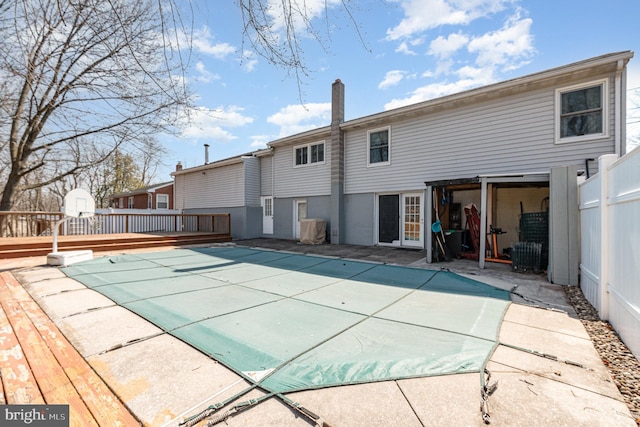 view of swimming pool with a patio area, a wooden deck, and fence