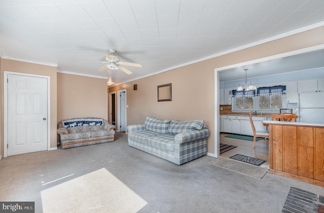 carpeted living room with baseboards, ornamental molding, and ceiling fan with notable chandelier