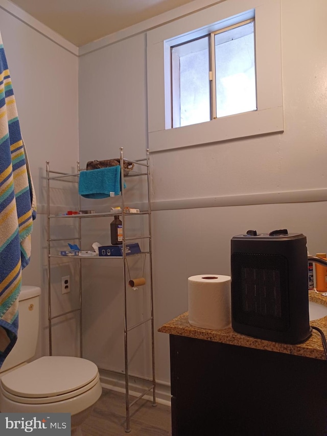 bathroom featuring toilet and wood finished floors