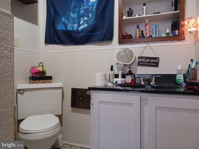 bathroom with toilet and vanity