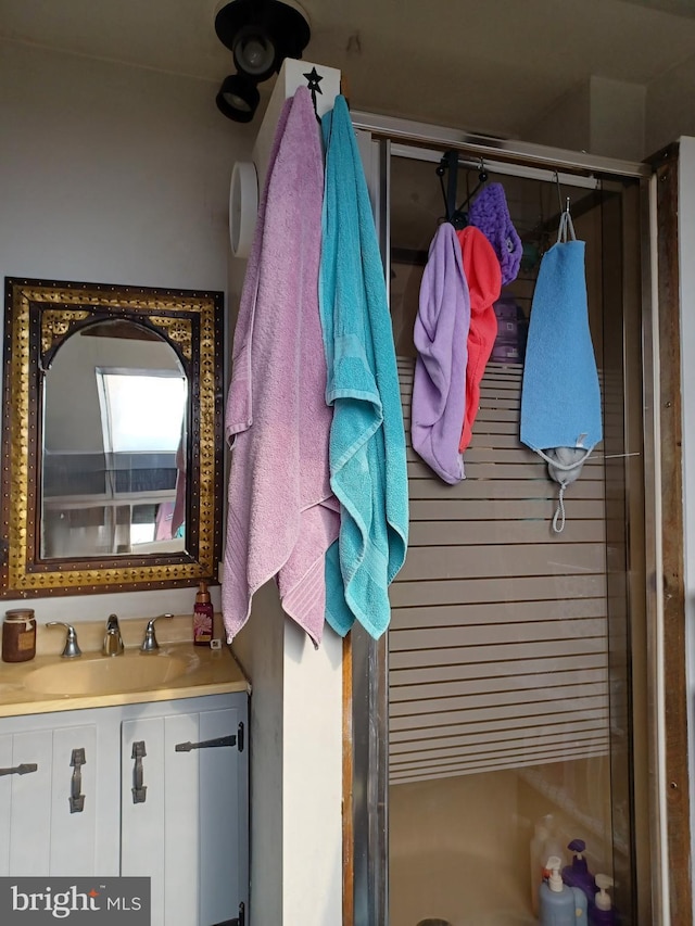 full bathroom featuring a shower stall and vanity