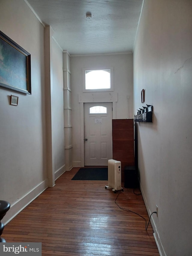 entrance foyer with crown molding, baseboards, and hardwood / wood-style flooring