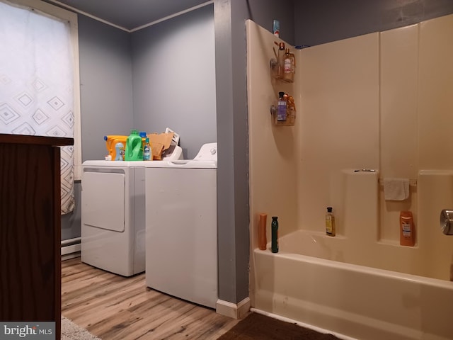 laundry area featuring crown molding, laundry area, washer and clothes dryer, and light wood-style floors