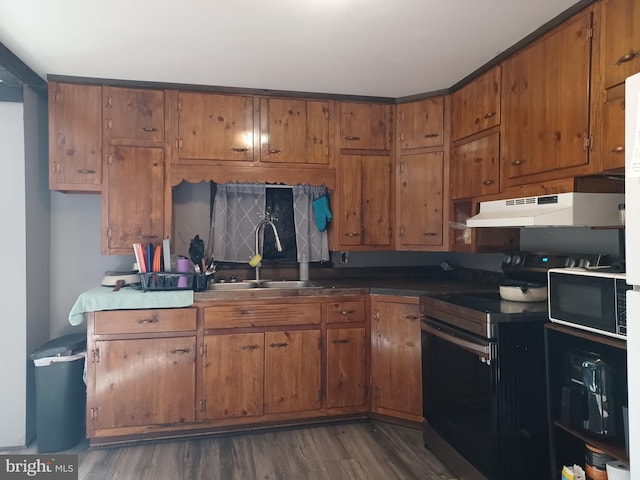 kitchen with electric stove, brown cabinets, a sink, black microwave, and under cabinet range hood