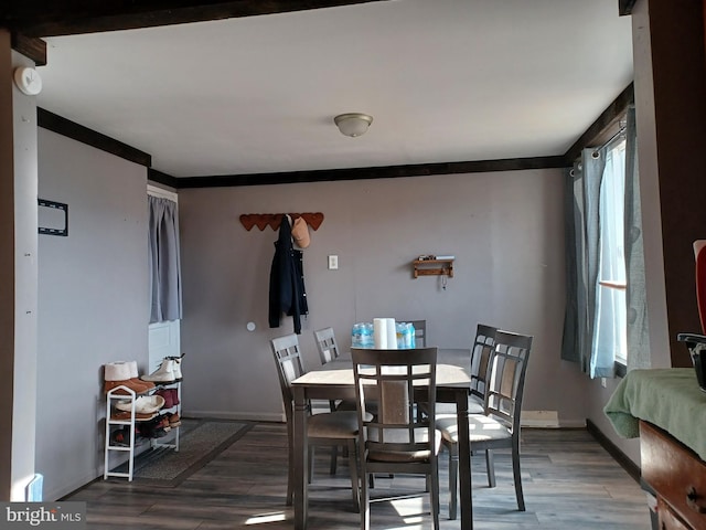 dining room featuring baseboards and wood finished floors