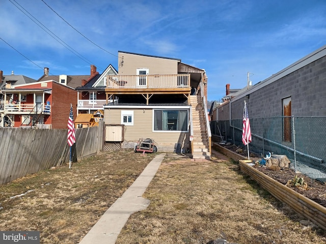 back of house with a fenced backyard