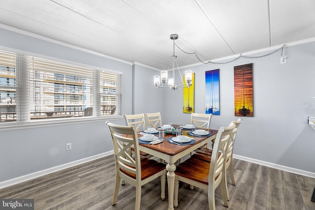 dining area featuring wood finished floors, baseboards, a chandelier, and ornamental molding