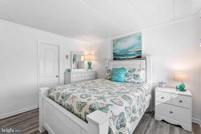 bedroom with wood finished floors and baseboards