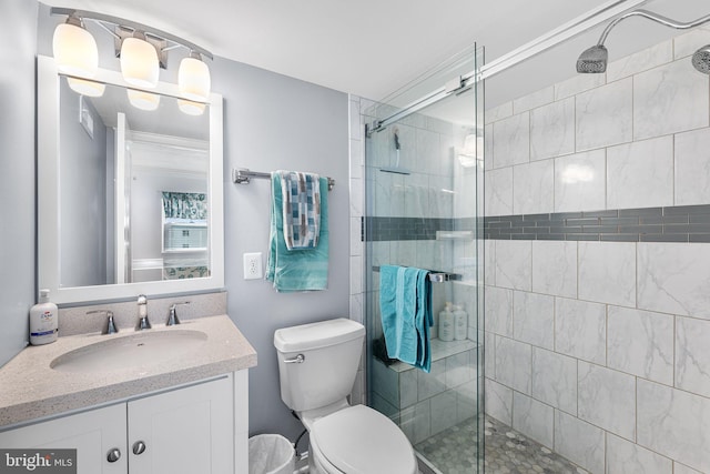 full bath featuring vanity, a shower stall, and toilet