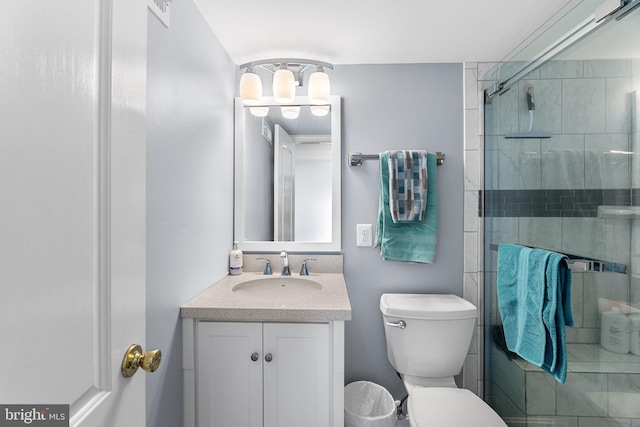 bathroom featuring visible vents, a shower stall, vanity, and toilet