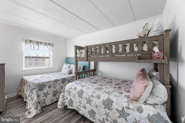 bedroom featuring crown molding and wood finished floors