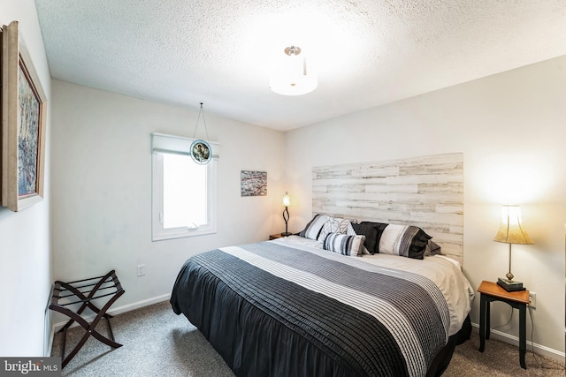 bedroom featuring a textured ceiling, carpet, and baseboards