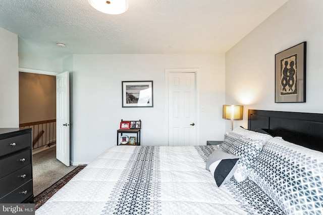 carpeted bedroom featuring a textured ceiling