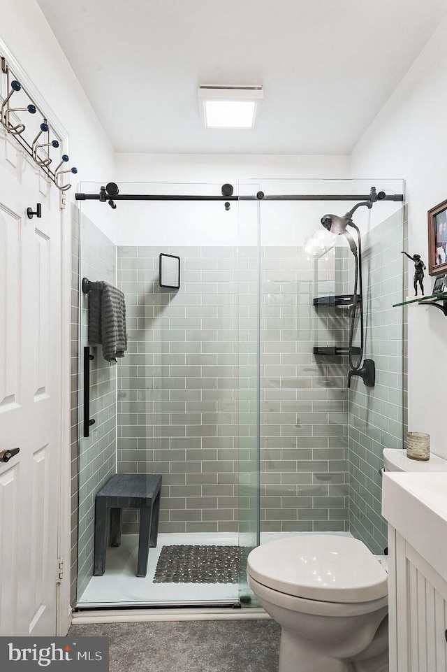 full bath with toilet, a shower stall, and vanity