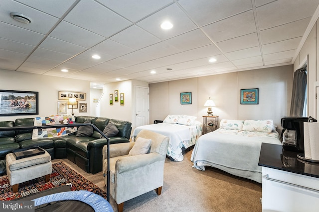 bedroom with carpet floors, recessed lighting, and a drop ceiling